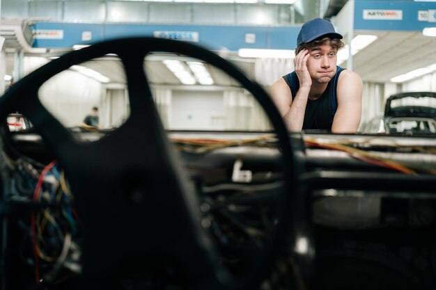 portrait-confused-mechanic-male-knowing-what-disrepair-maintenance-car-auto-repair